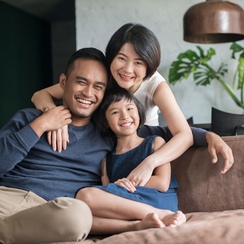 family on couch smiling